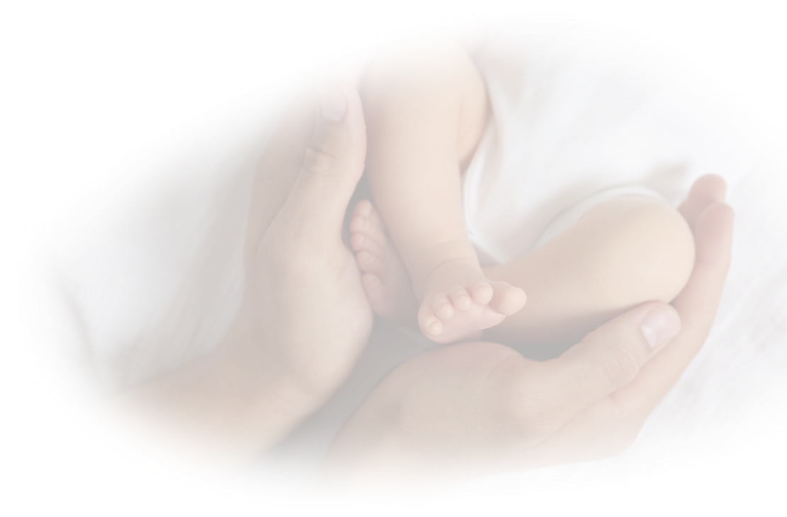 Parents holding their newborn baby's feet with care