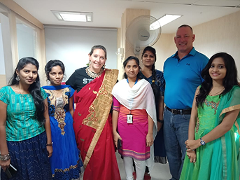 Employees celebrating festival in traditional attire at workplace